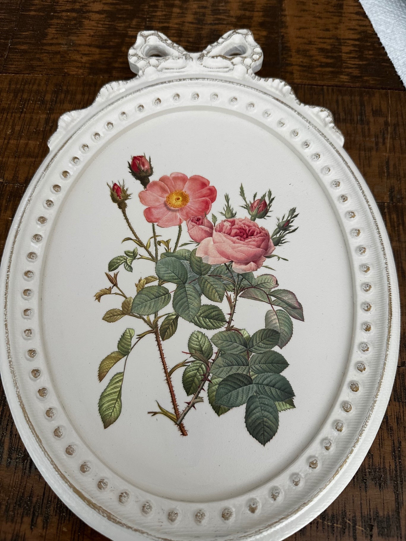 White oval picture with pink flowers