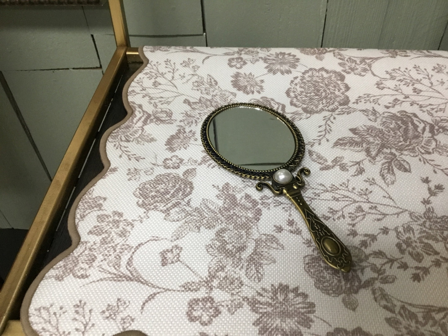 Ornate hand mirror