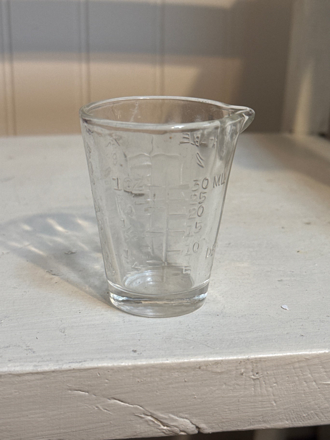 Vintage glass measuring cup with Porsche belt