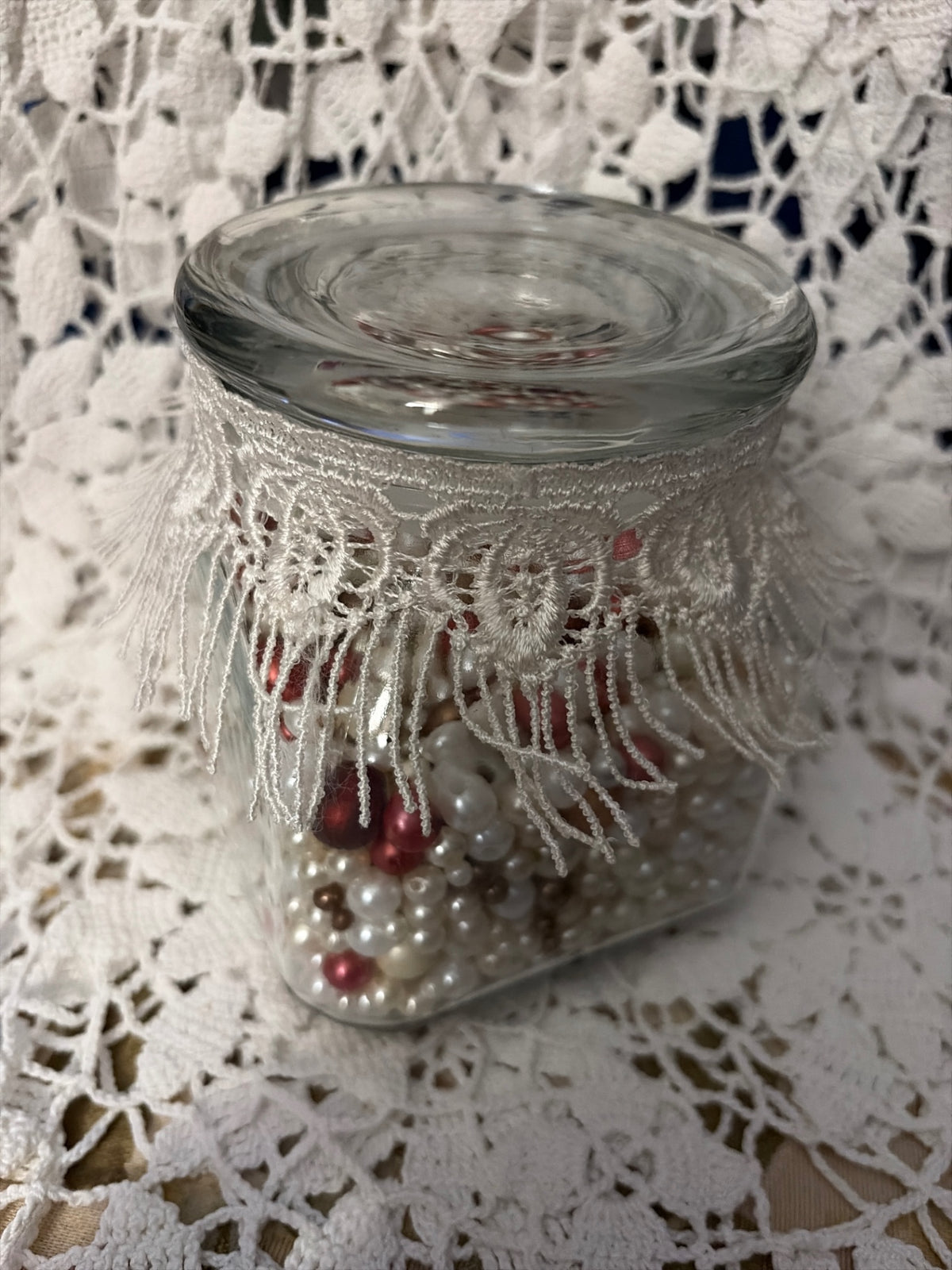 Square jar of craft pearls