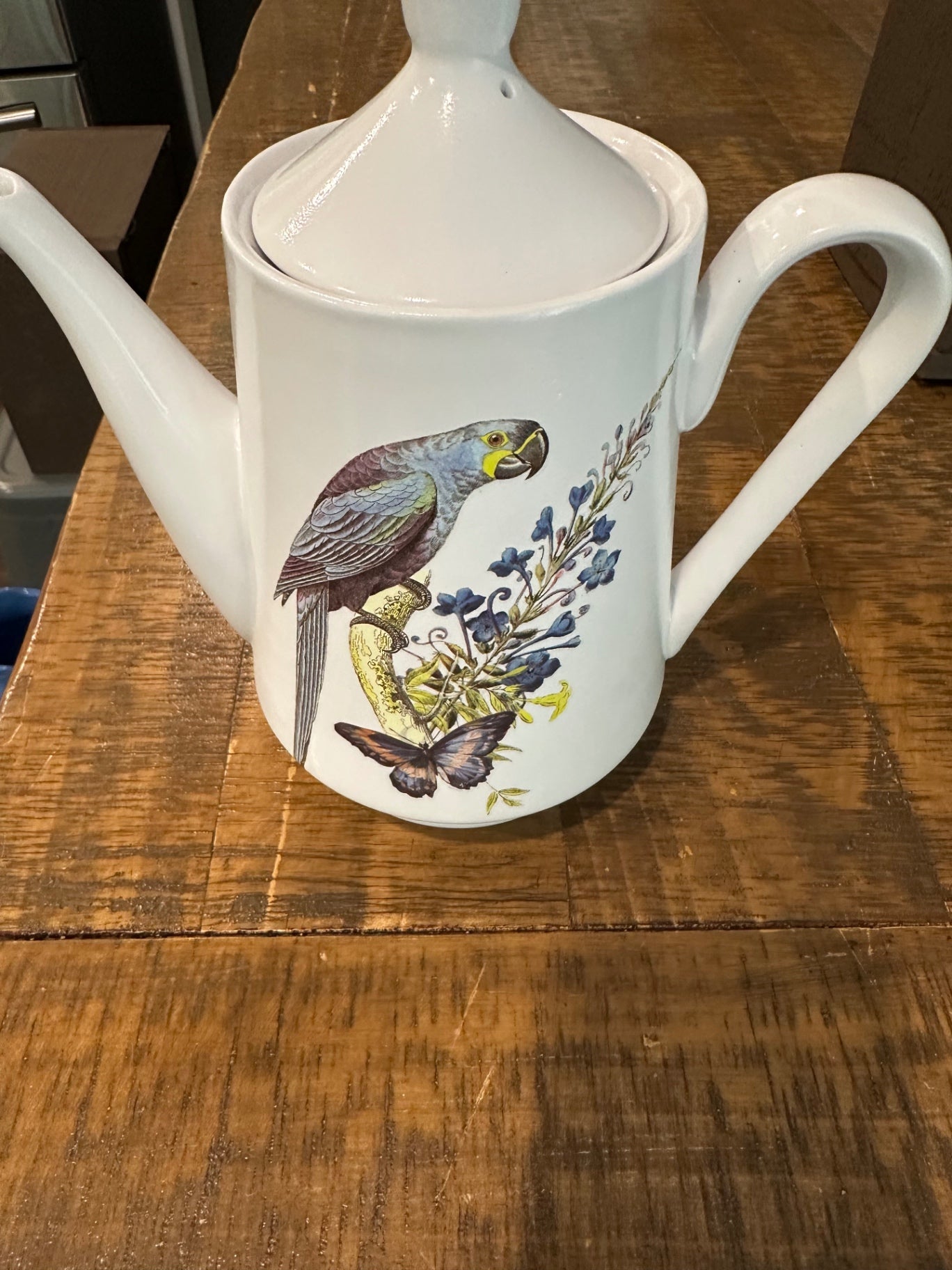 White pitcher with blue parrot