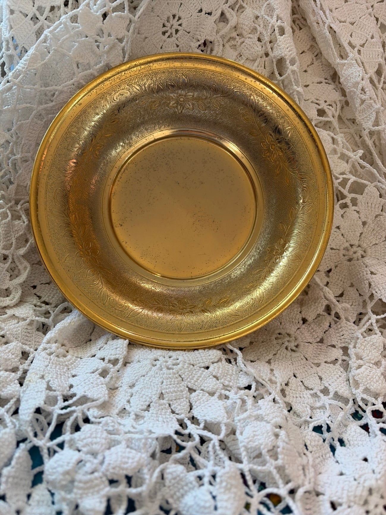 Vintage brass plate with floral etching.