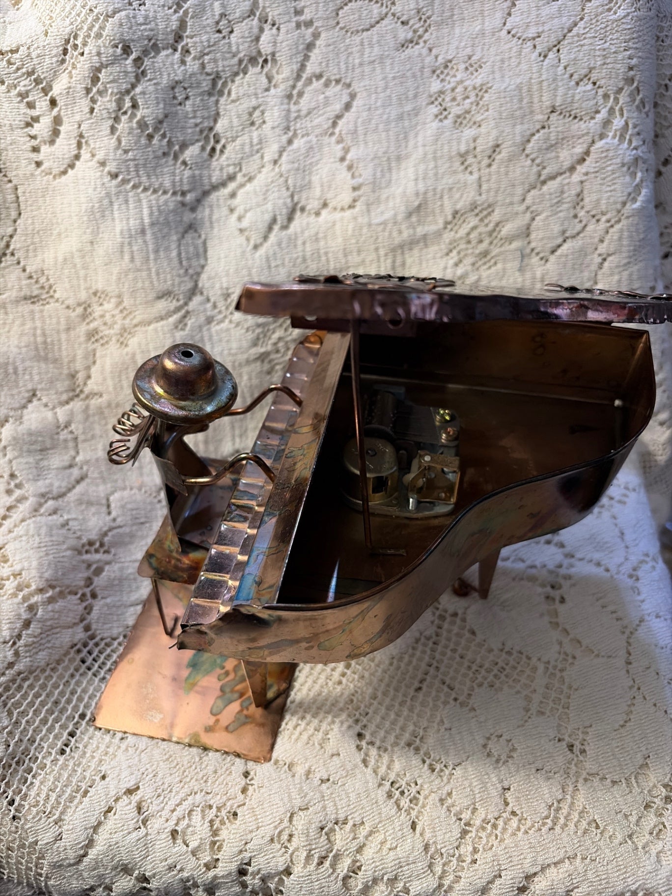 Copper colored girl on piano music box