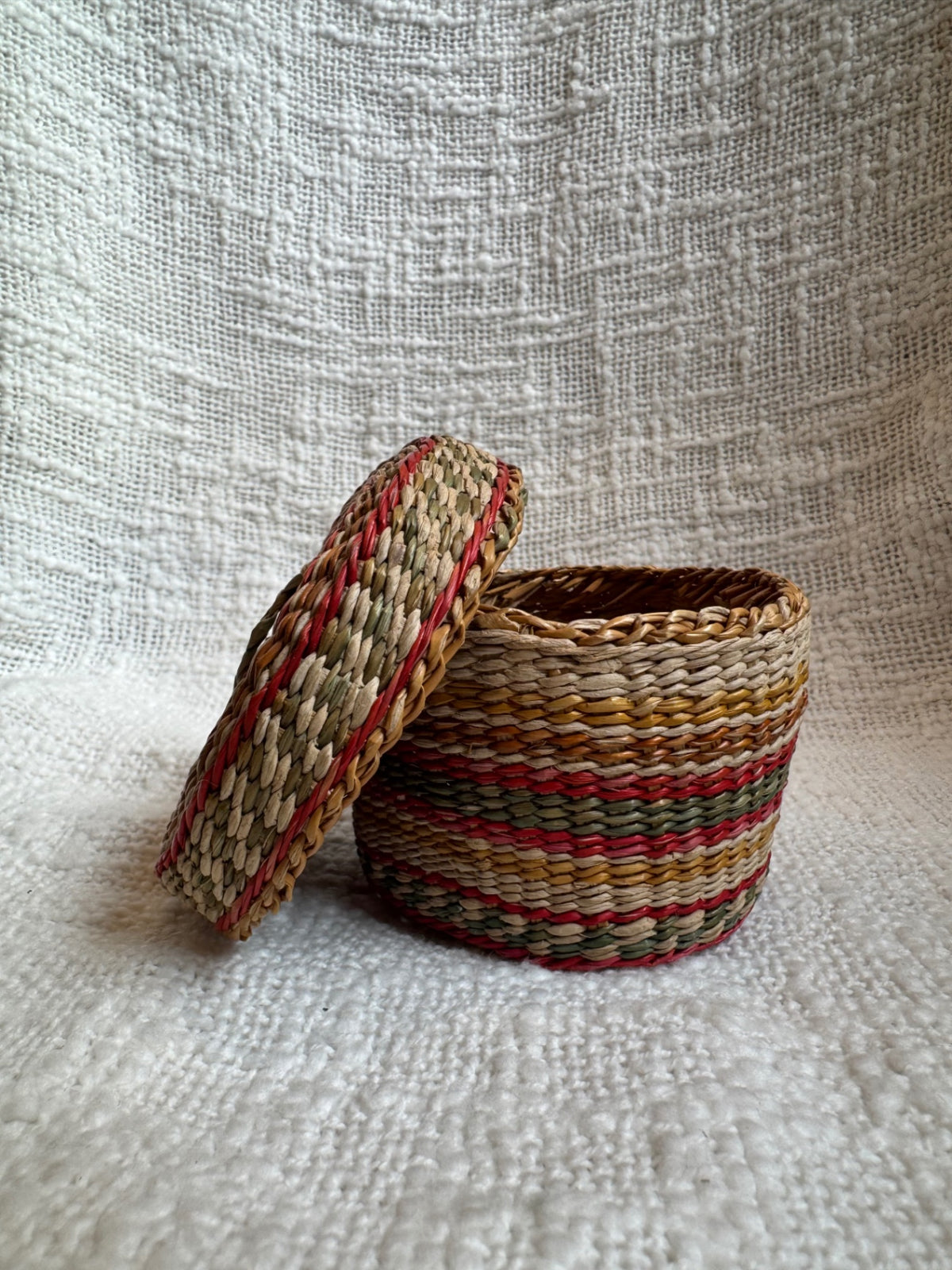 Multi colored sweet grass woven basket w/ lid