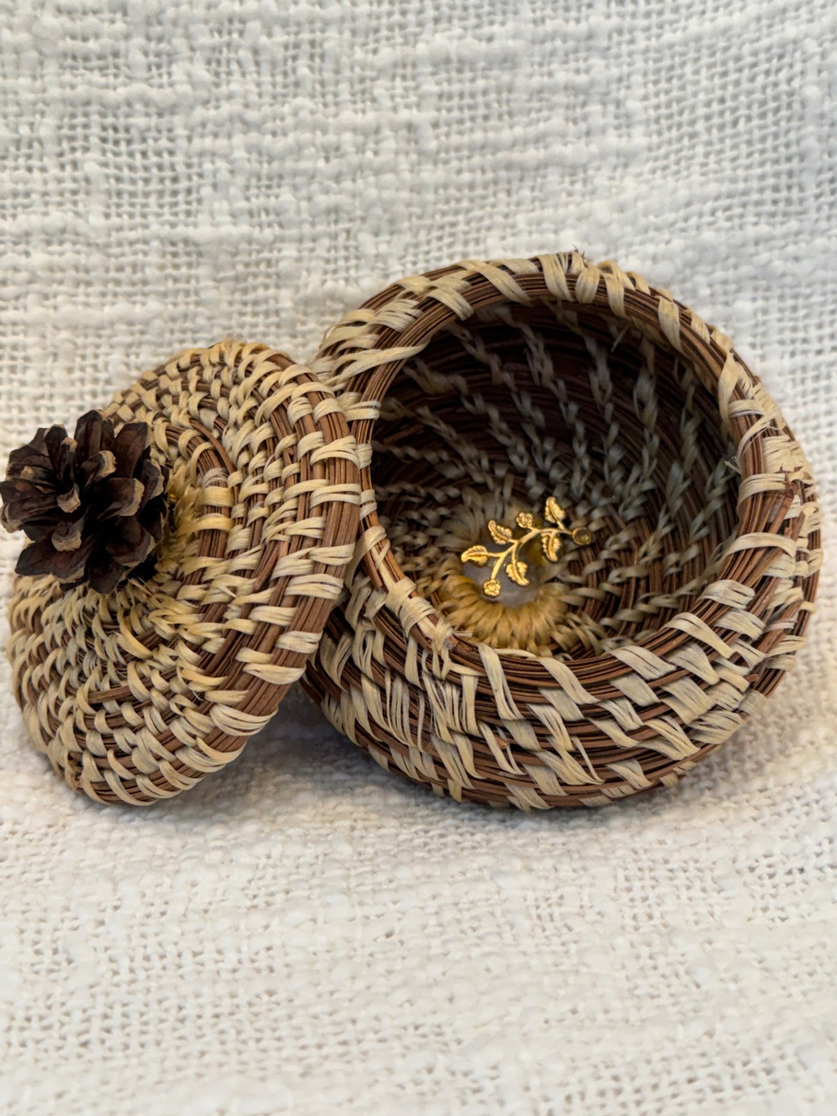 Pine needle basket with pinecone topped lid