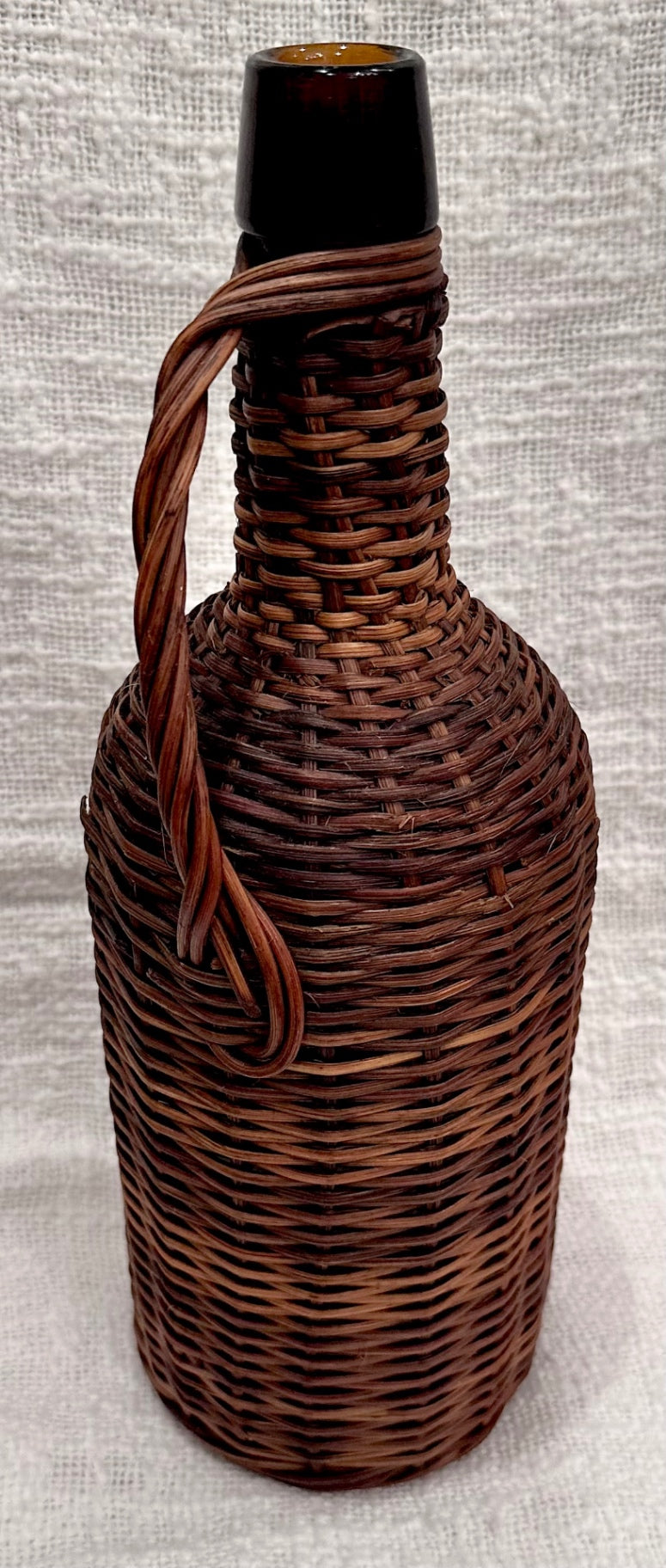 Wicker covered Amber glass demijohn