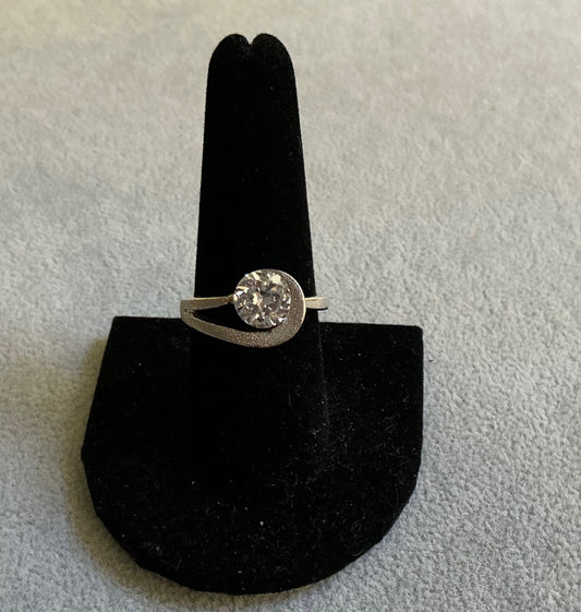 Silver- tone ring featuring a large CZ stone. 