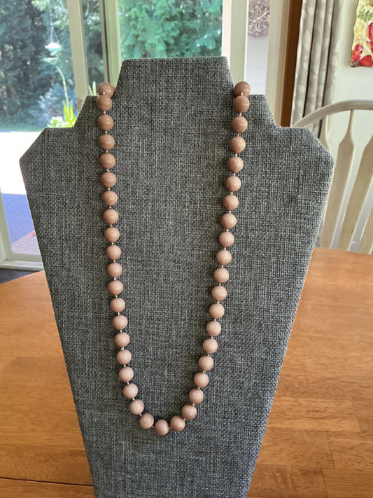 Taupe colored strand necklace. 