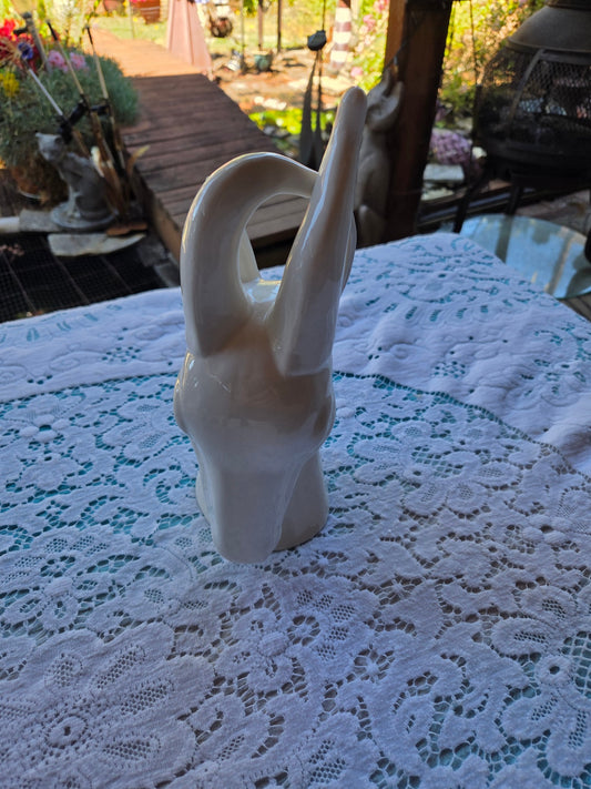 Three hand sculpture deer