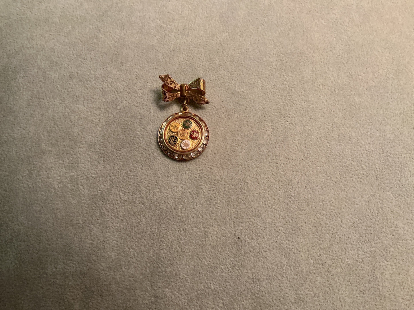 Gold colored brooch with rhinestones 