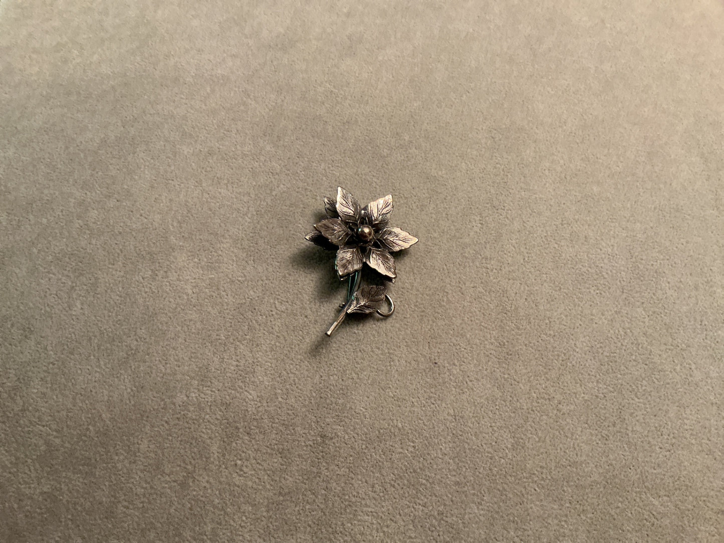 Silver colored flower brooch