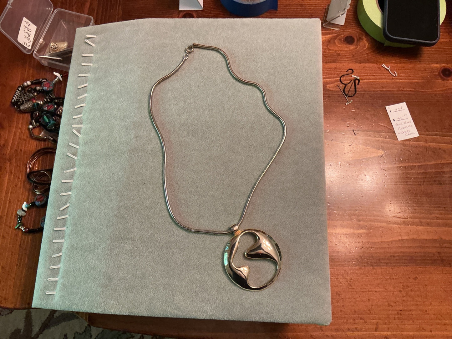 Gold toned necklace with snake chain