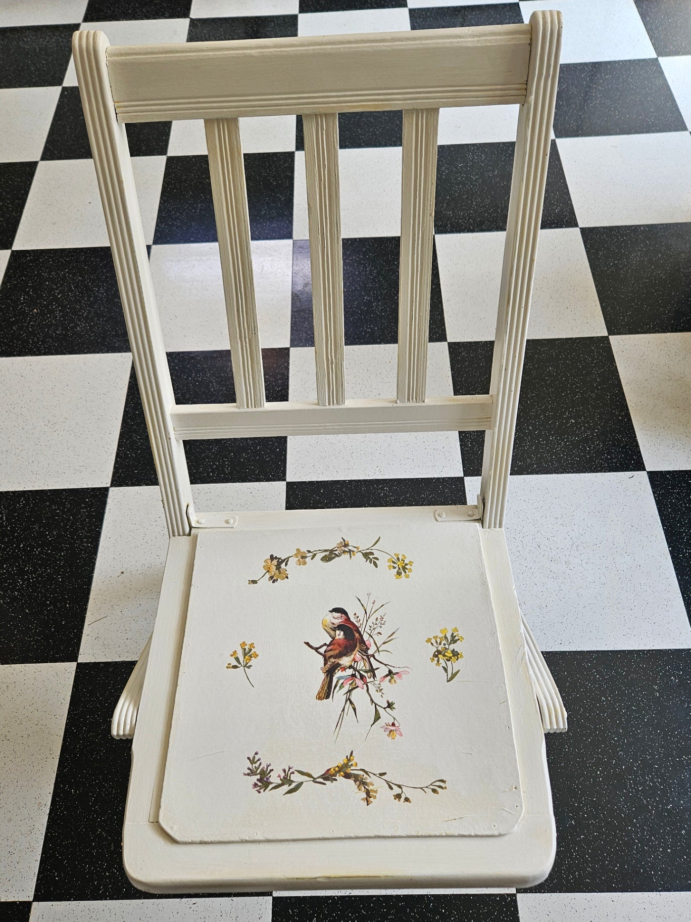 Vintage white folding chair with bird/floral design