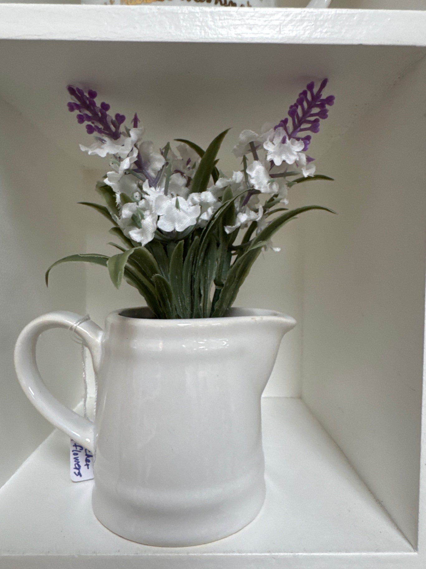 White pitcher of flowers