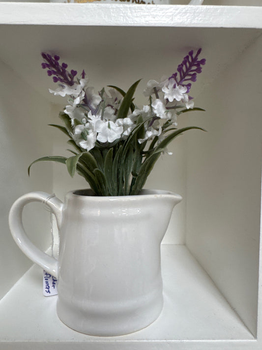 White pitcher of flowers