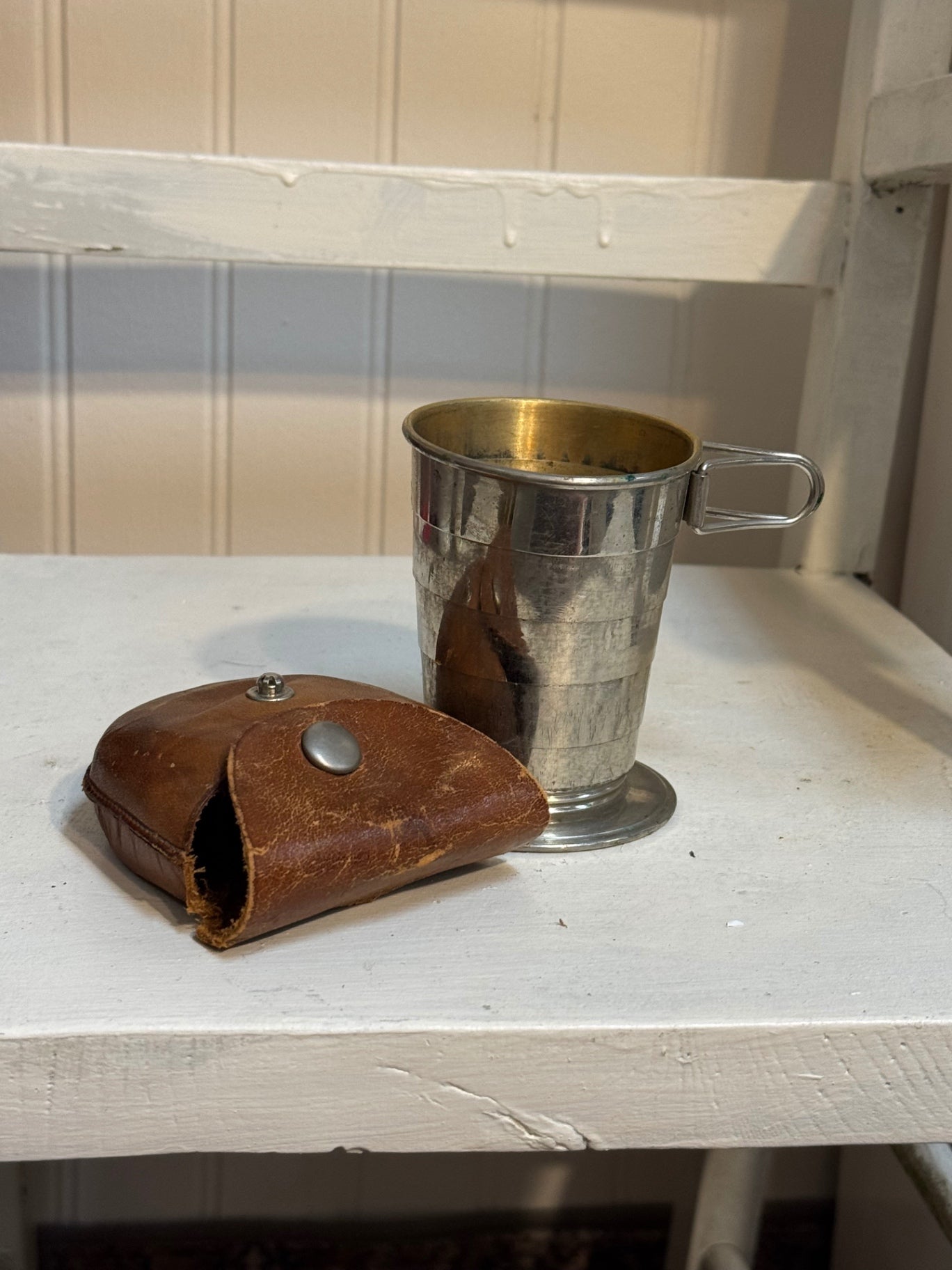 Collapsible travel cup in leather pouch