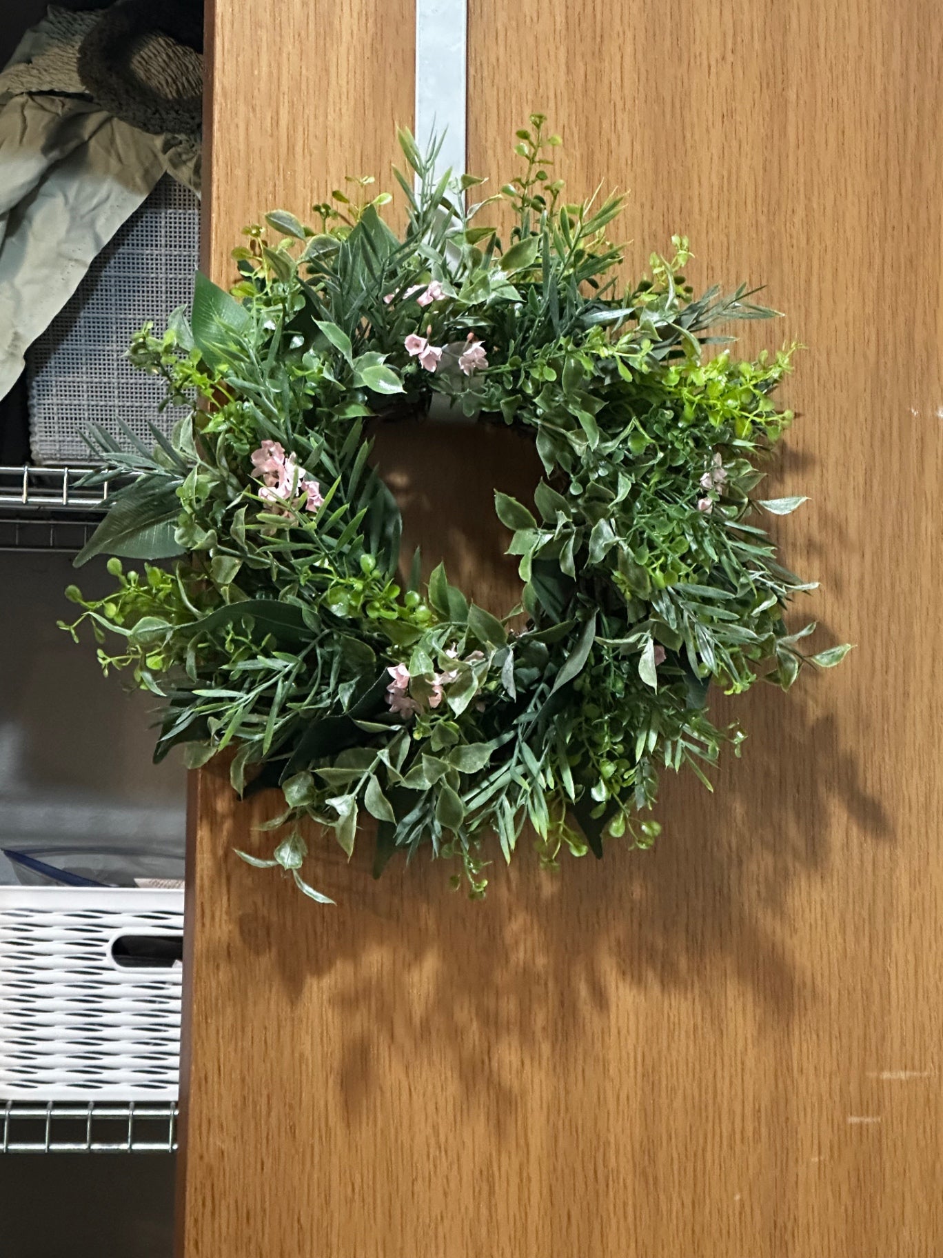 Wreath with greenery and pink flowers