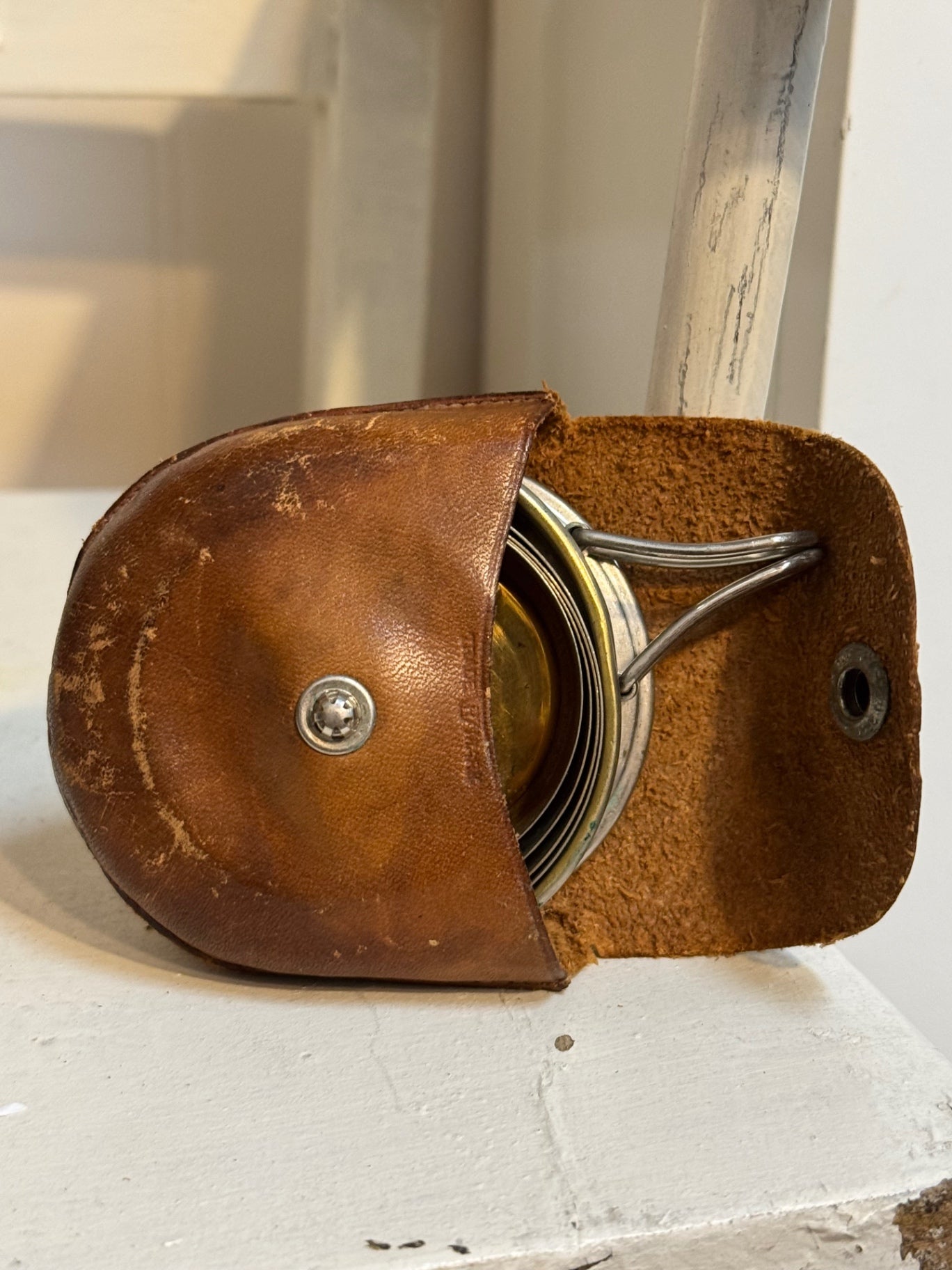 Collapsible travel cup in leather pouch