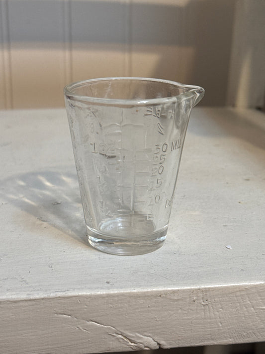 Vintage glass measuring cup with Porsche belt