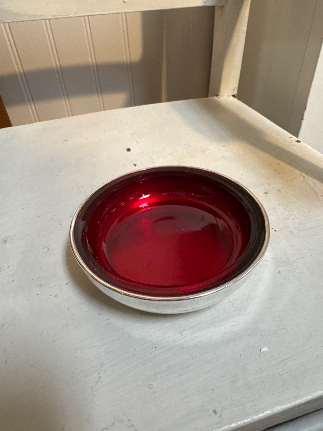 F.B. Rogers silverplate coaster with a vibrant ruby red glass interior.