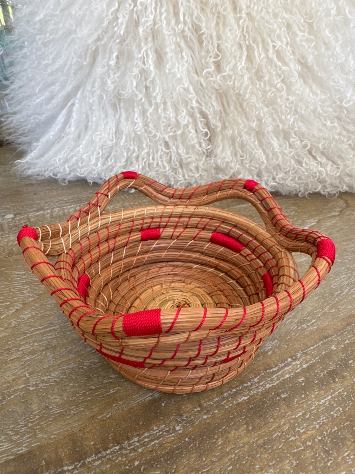 Coiled pine needle basket w/ red stitching 