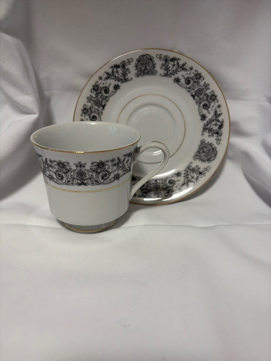 White with black floral design cup and saucer.