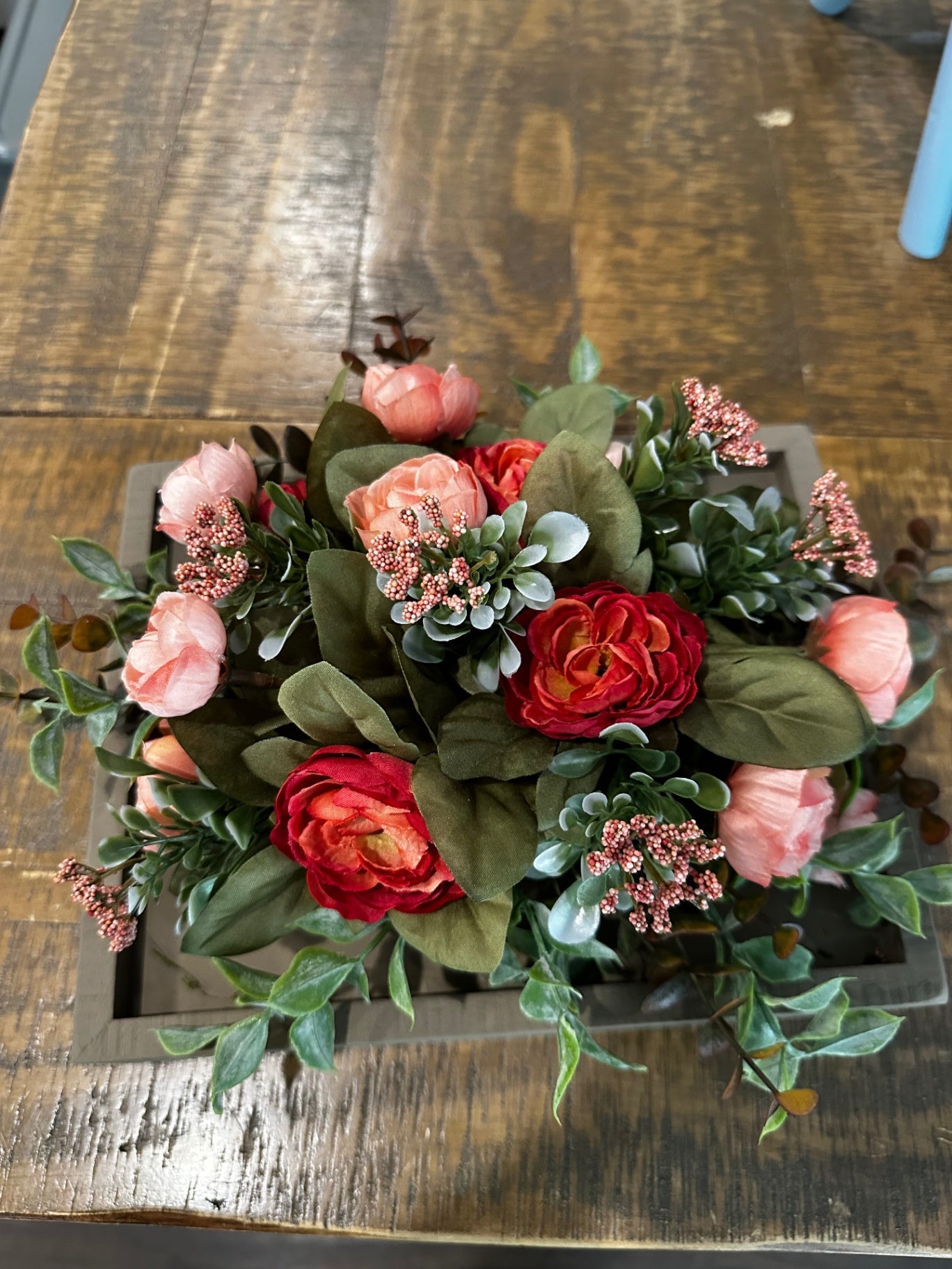 Floral arrangement on square frame