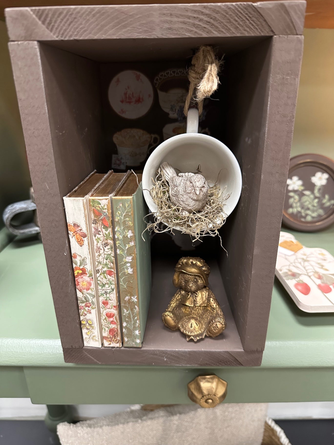 brown box with books teacup and bear