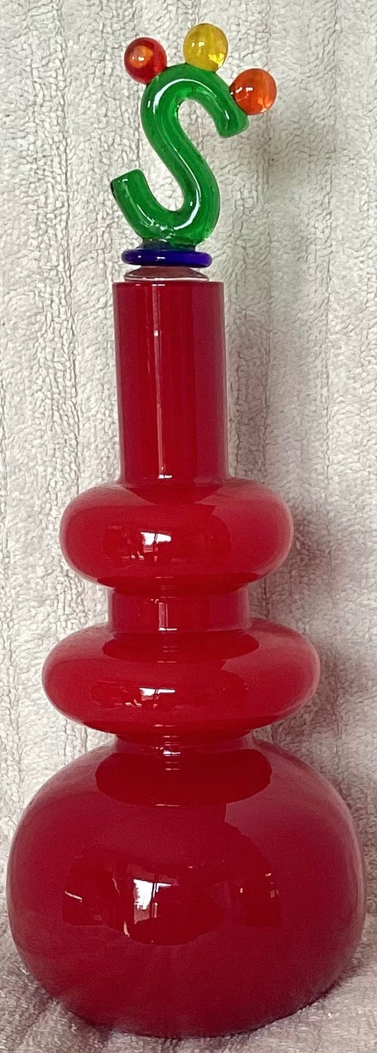 Decorative red decanter with ornate stopper