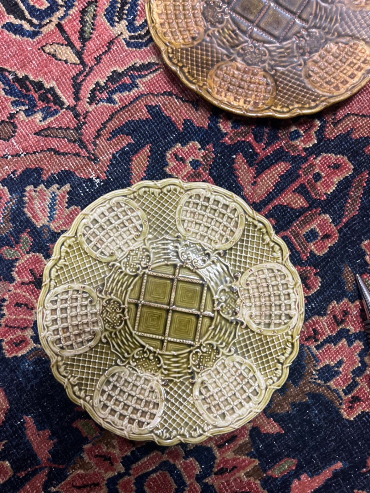 vintage majolica ceramic plate features an intricate olive green and cream basket-weave