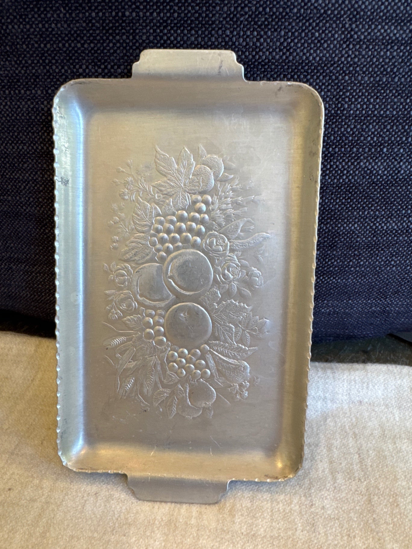 vintage mid-century hand-wrought aluminum tray features a charming embossed fruit and harvest