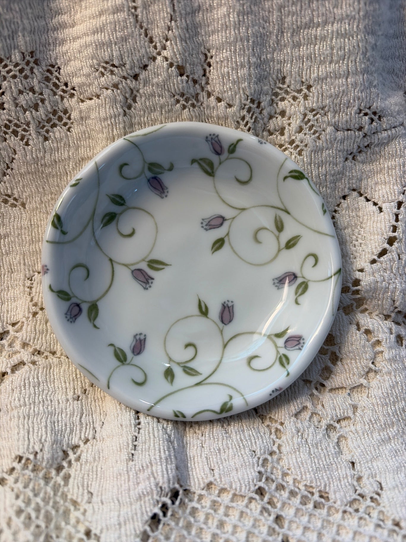 Butter pad dish with purple flower buds.