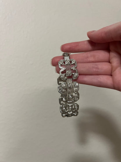 Small clasp bracelet with silver tone and clear gems