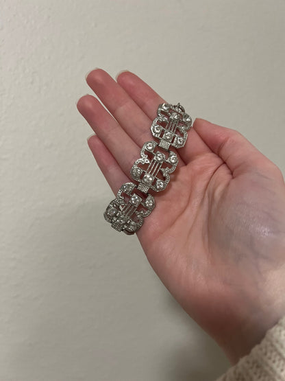 Small clasp bracelet with silver tone and clear gems