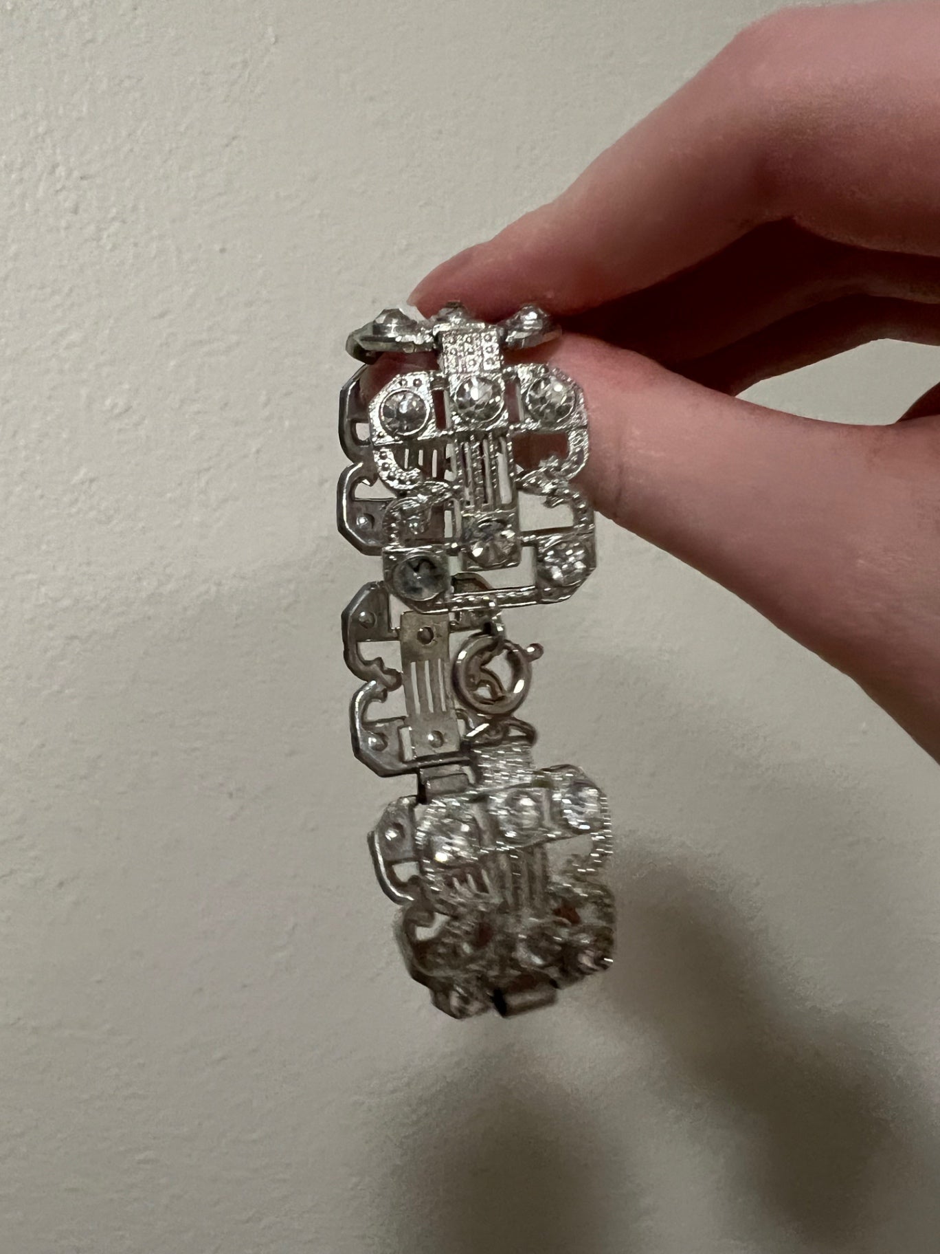 Small clasp bracelet with silver tone and clear gems