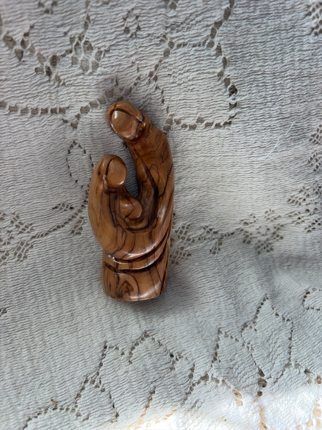 Holy family carved from olive wood. 4”