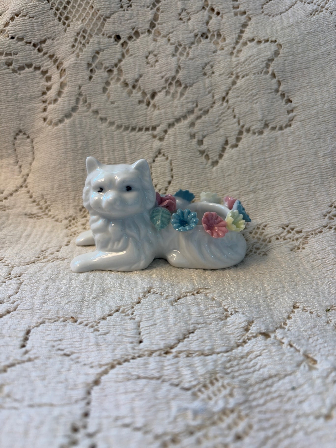 White cat with porcelain colored flowers