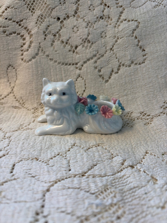 White cat with porcelain colored flowers