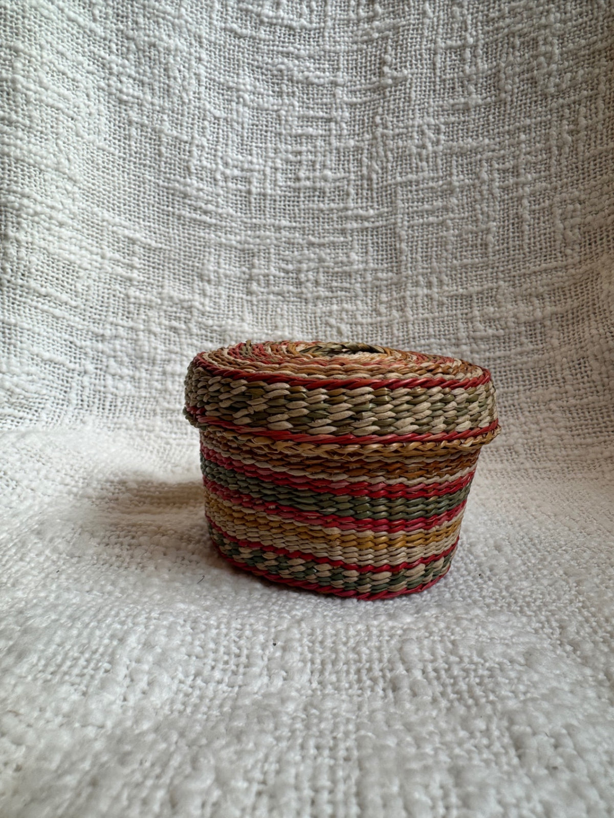 Multi colored sweet grass woven basket w/ lid 