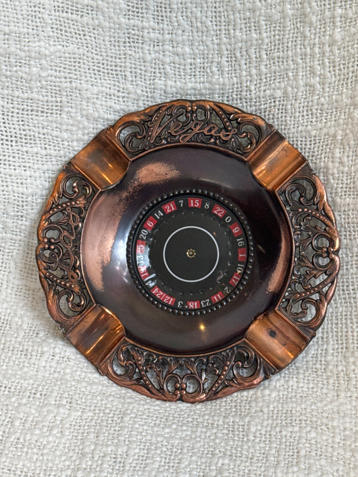 vintage copper-tone or brass Las Vegas roulette wheel spinning ashtray, 1970s.