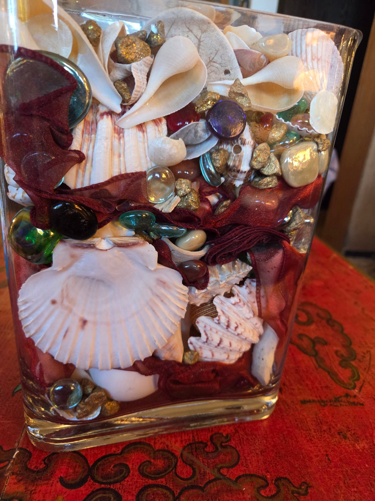 Glass vase filled with shells and treasures