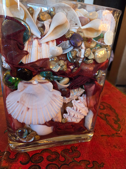 Glass vase filled with shells and treasures