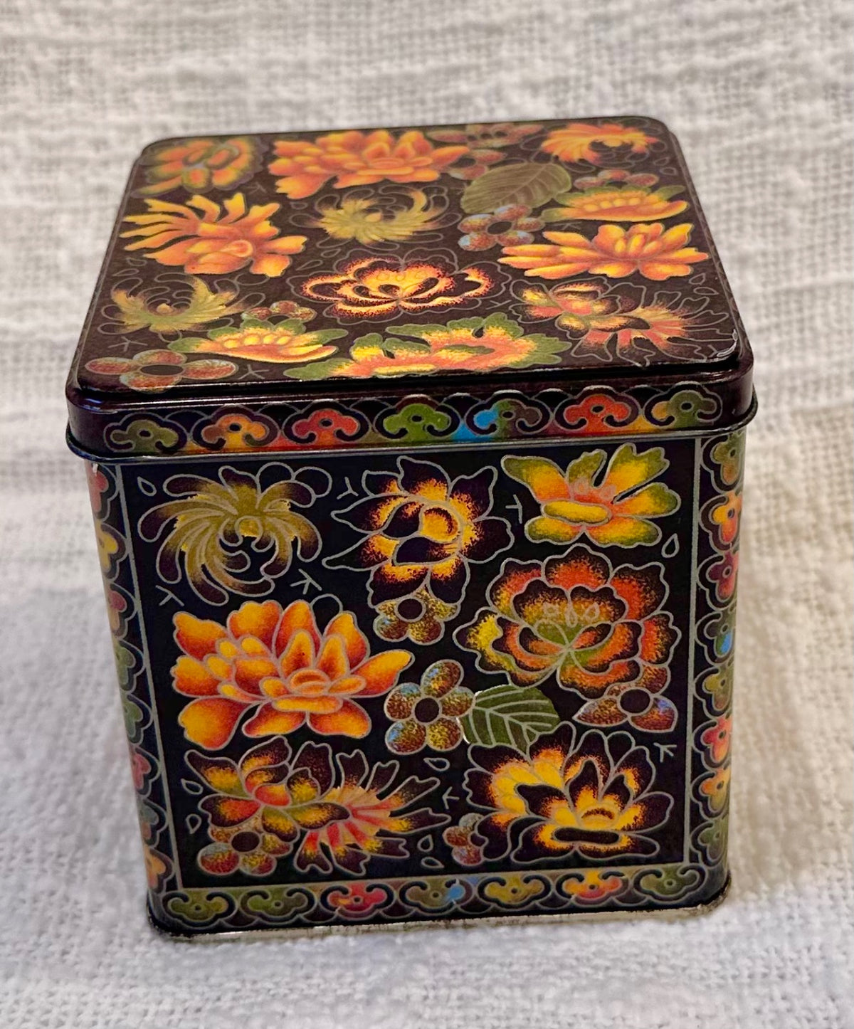 Orange & black vintage floral tin 