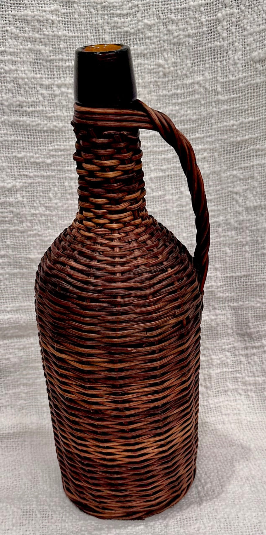 Wicker covered Amber glass demijohn 